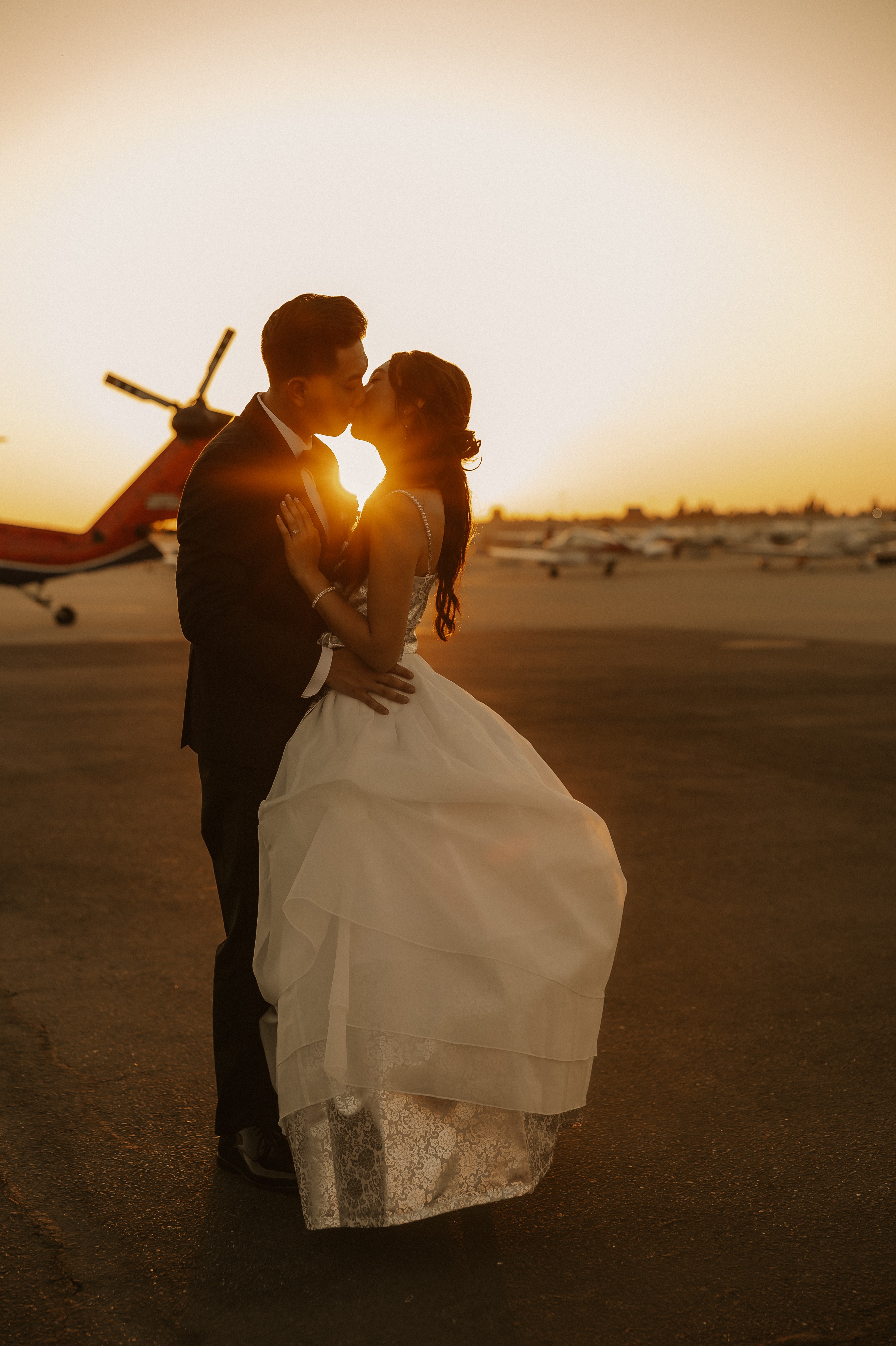 Romantic sunset kiss at the airfield