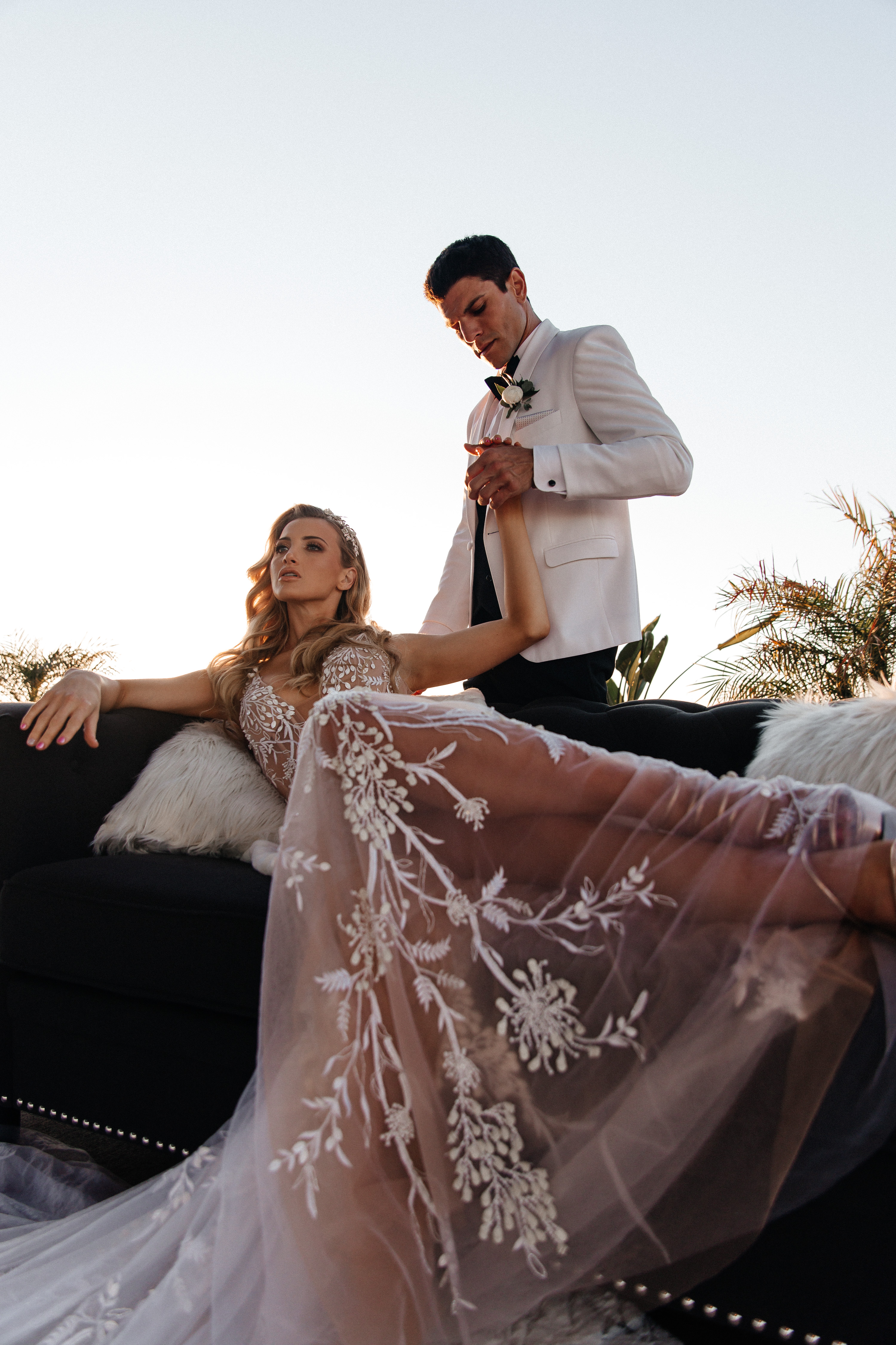 Editorial bride and groom on velvet couch